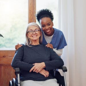 A woman in a wheelchair with another person.